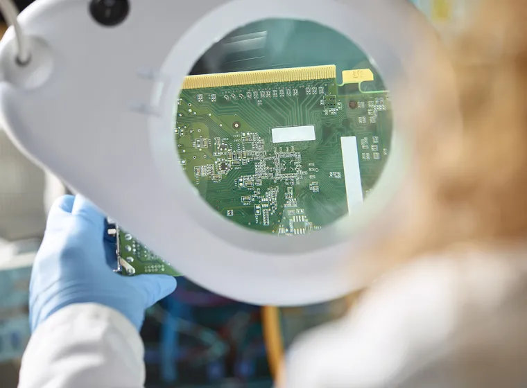 An Engineer evaluating electronic components. Exponent electrical engineers and computer scientists consult on electronics.