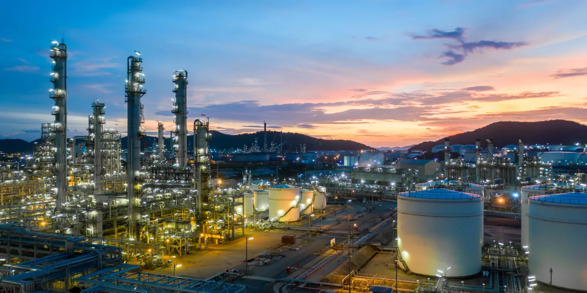 Aerial view oil and gas tank with oil refinery background at night, Glitter lighting of petrochemical plant with night, Manufacturing of petroleum, Products tank in petrochemical plant