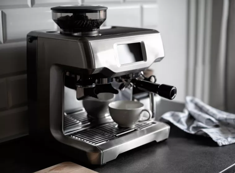 A esspresso maker sits on a kitchen cabinet. Exponent engineers help manufacturers evaluate, test, and improve safe products.