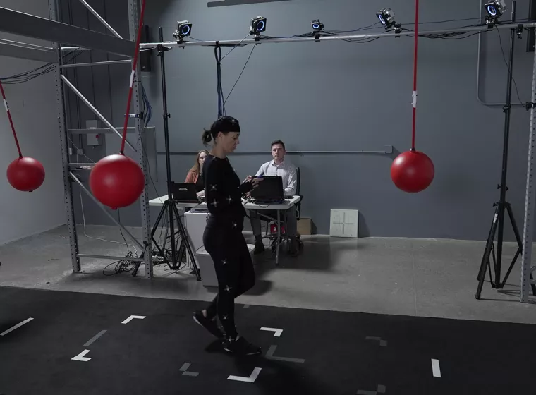 Test subject in research lab surrounded by red balls. Exponent evaluates user behaviors to help create safer, resilient products.