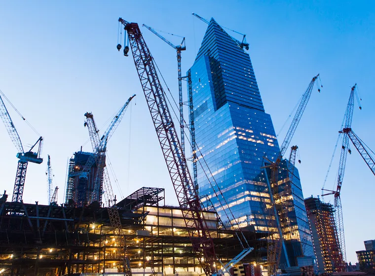 Skyscrapers surrounded by industrial cranes. Exponent provides superior construction engineering services.