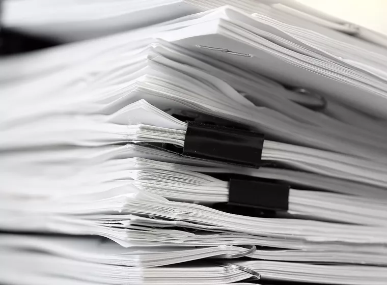 A stack of legal papers on a desk. Exponent provides technical expertise for all types of legal claims and disputes. 