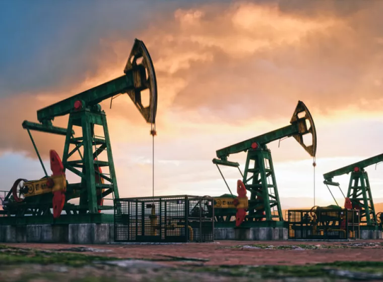 Oil derricks at sunset. Exponent helps stakeholders improve the efficiency and safety of oil and gas exploration and production.