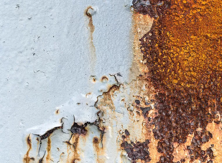 Exposed rust and flaking material on an exterior surface. Exponent materials and corrosion engineering support.