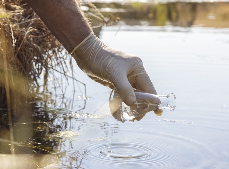 Collecting water samples to evaluate for chemical toxicity. Exponent helps identify chemical contamination sources.