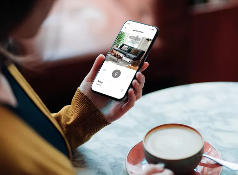 [EECS] Displays - person holds a phone with backlit screen while drinking coffee