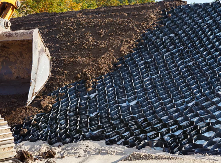 Polymer earth stabilization grid installed to prevent hillside erosion. Exponent civil engineering support for earth engineering.