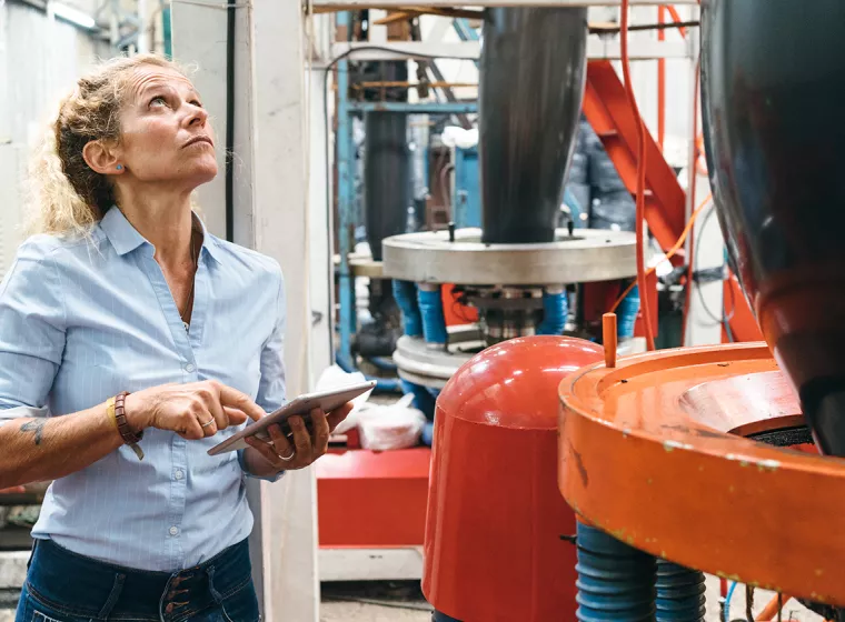 A person inspects a factory. Exponent provides chemical and regulatory support for all industries.