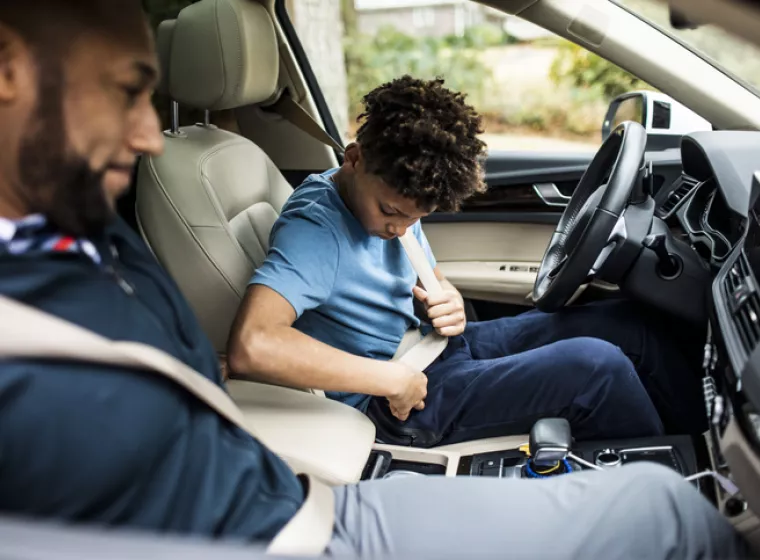 Father teaching son to drive