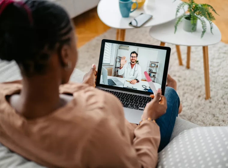 Young Pregnant Woman Having A Doctor's Appointment On A Laptop