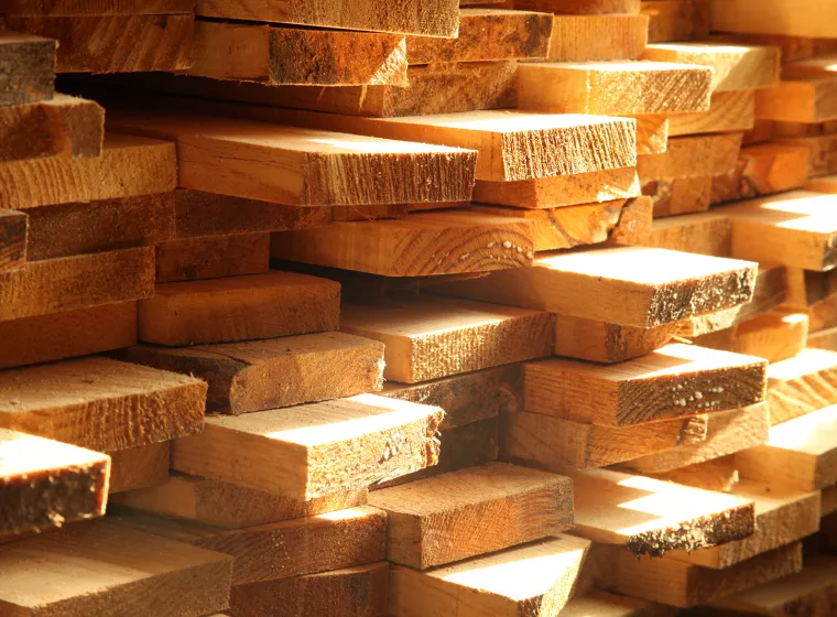 Stack of fresh milled lumber. Exponent construction engineers evaluate building materials.