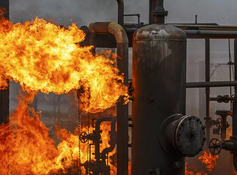 Industrial gas pipes in a blaze of fire. Exponent performs investigations of fluid combustion systems.