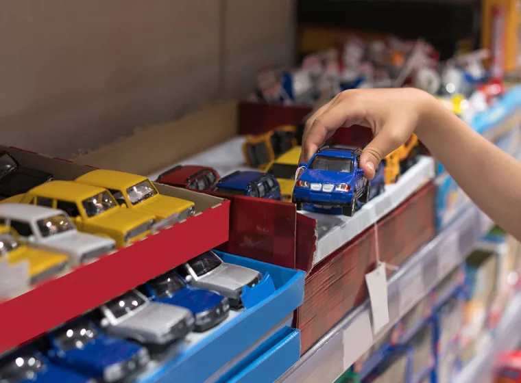 A young child plays with toy cars. Exponent Ph.D. scientists and engineers help manufacturers produce safer consumer products.