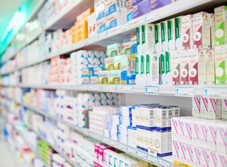 Over-the-counter drugs line shelves in a pharmacy 