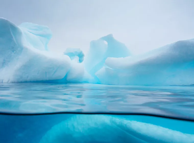 Beautiful glacial iceberg rising from the water. Exponent helps you manage environmental resources.