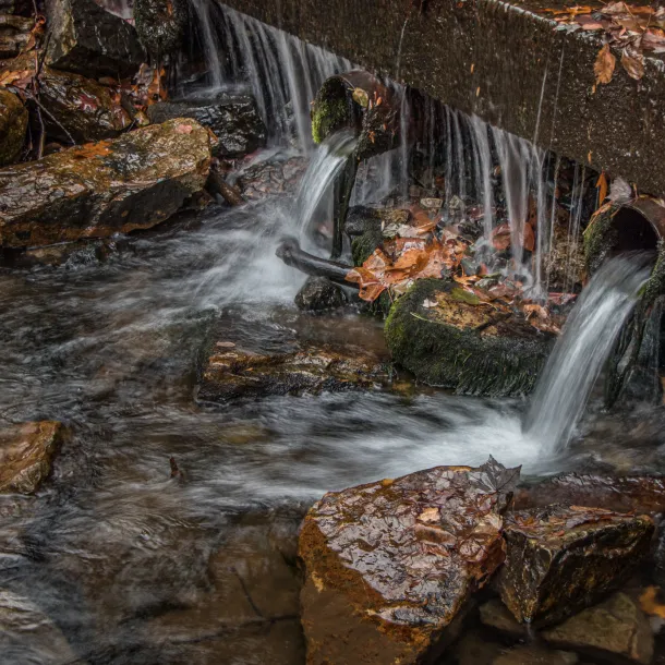 Stormwater flows from pipes into a stream