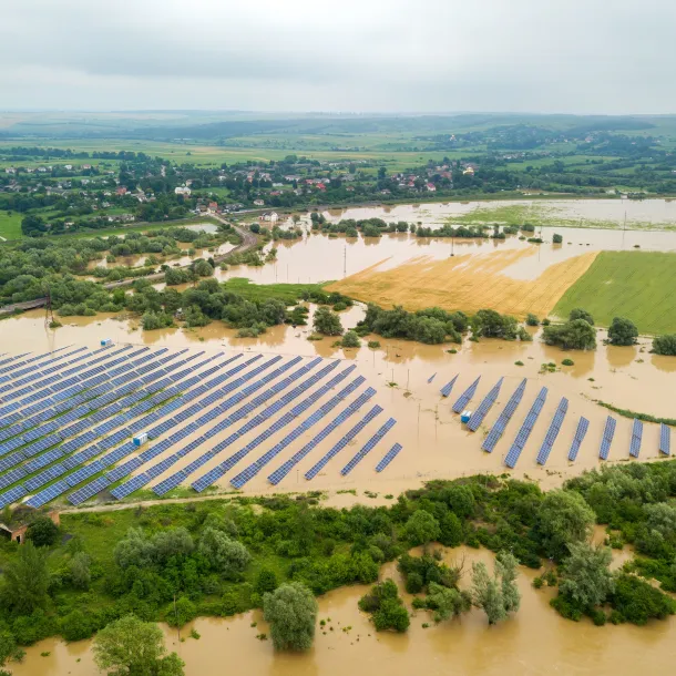 Aerial view of flooded solar power station with dirty river water in rain season