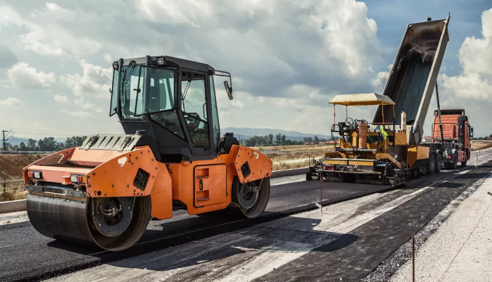 Steamroller running over asphalt on highway