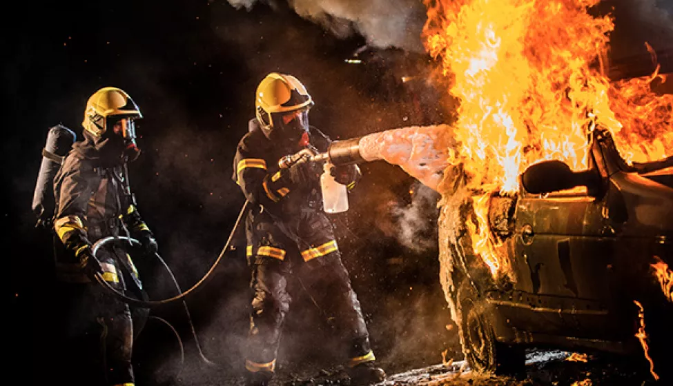 firefighters trying to put out car fire