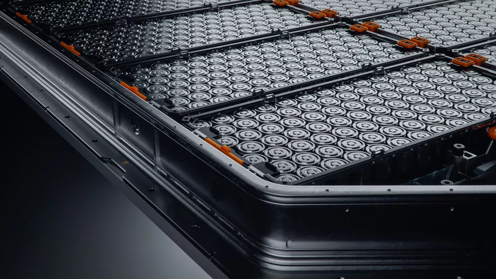 Close-up of EV Battery Pack with Orange Connectors Isolated on Black Background