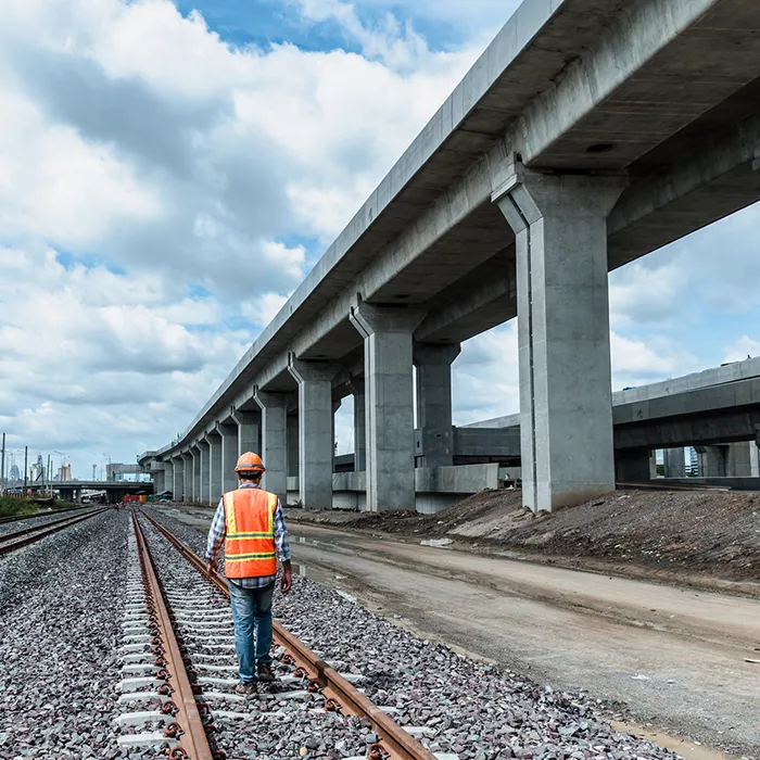 Worker walks along railroad tracks