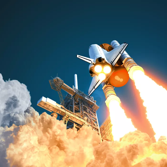 Space shuttle takes off on background of blue sky