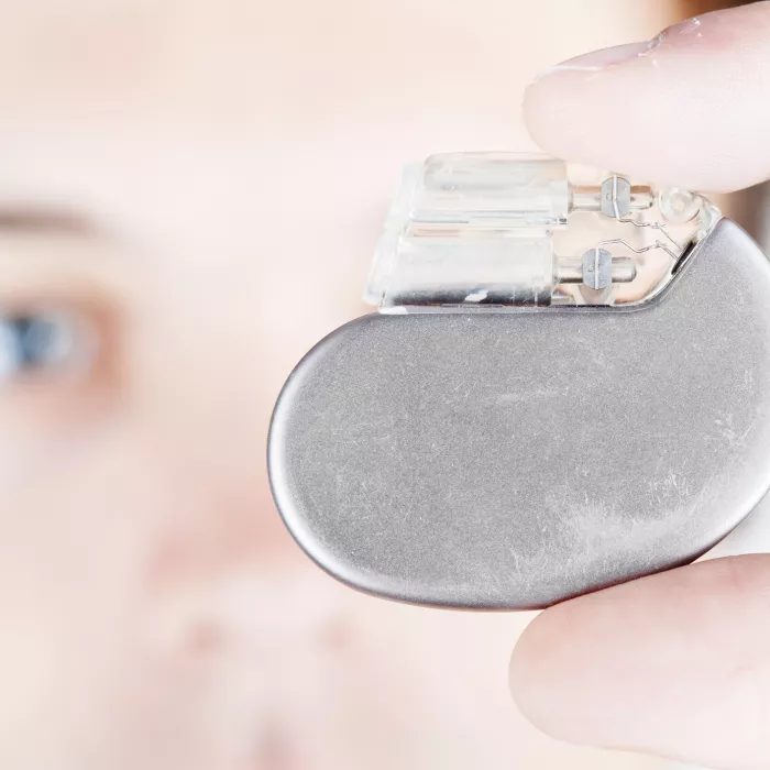 A man holding a cardiac pacemaker