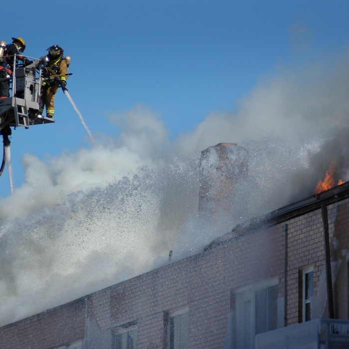 Firefighters extinguishing a burning building