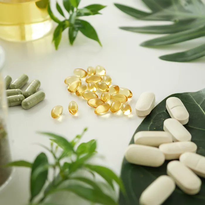 Pills grouped on a table with leaves