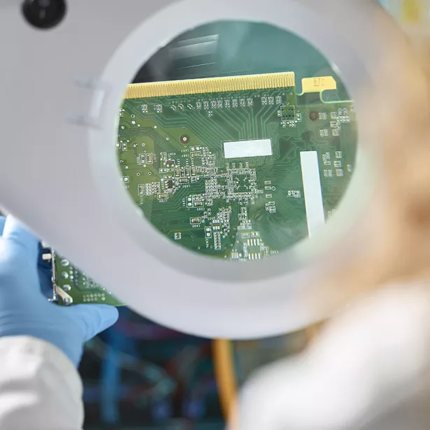 An Engineer evaluating electronic components. Exponent electrical engineers and computer scientists consult on  electronics.