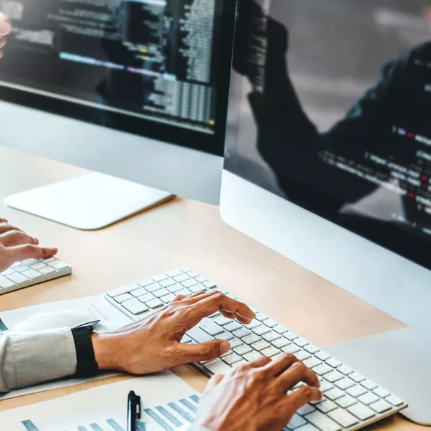 Hands typing on a keyboard while analyzing data on a computer screen. Exponent helps enhance the platforms and systems that drive business.