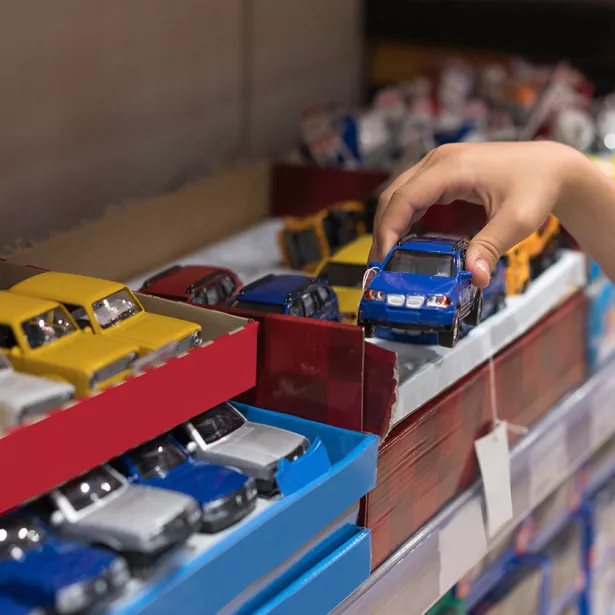 A young child plays with toy cars. Exponent Ph.D. scientists and engineers help manufacturers produce safer consumer products.