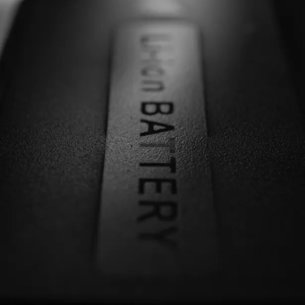 Close-up, black and white view of Li-ion battery labelled "Li-ion BATTERY"