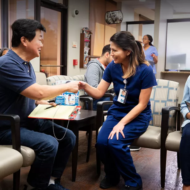 A medical professional shakes hands with a patient. Exponent gathers real world data and evidence to improve health science initiatives. 