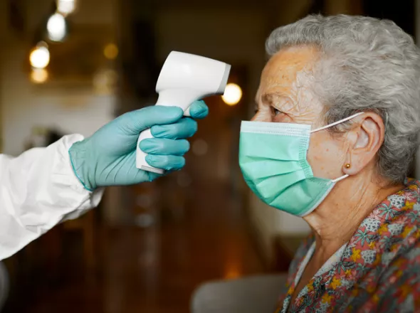 Woman Having Temperature Taken