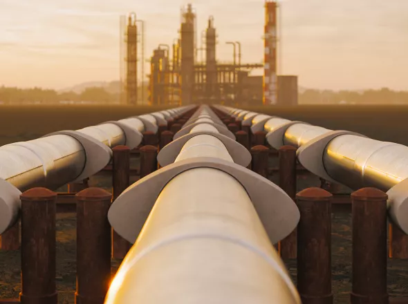 A picture of a long oil and gas pipeline. Exponent materials engineers analyze corrosion and help improve pipeline materials. 