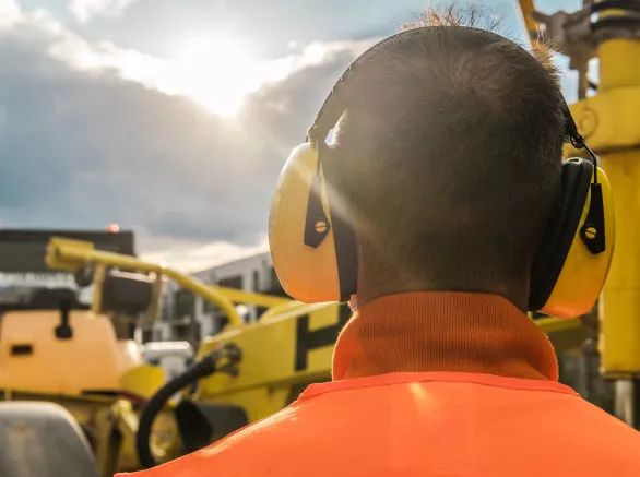 Construction worker wearing noise reduction headsphones