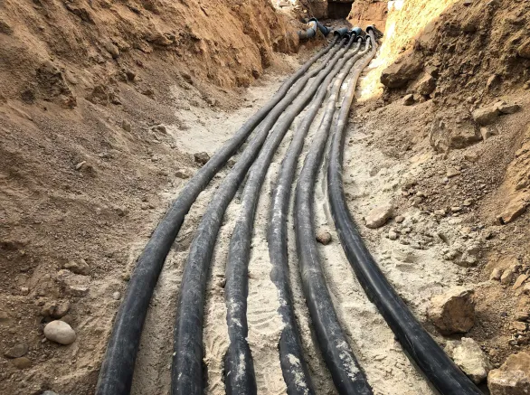 The high voltage electrical cable is laid in a trench