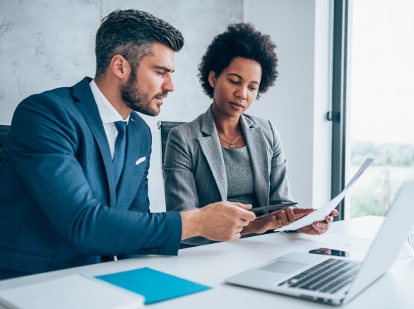 Two colleagues work together in an office setting