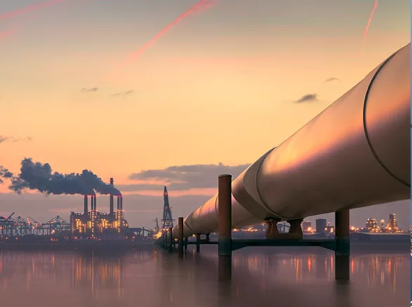 Oil pipeline stretching over the ocean with city background. Exponent helps improve efficiency and safety of oil and gas pipeline. 