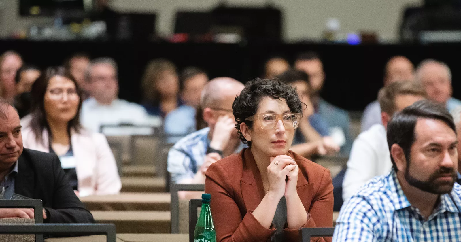 A group of Exponent consultants seated in a conference watching a presentation