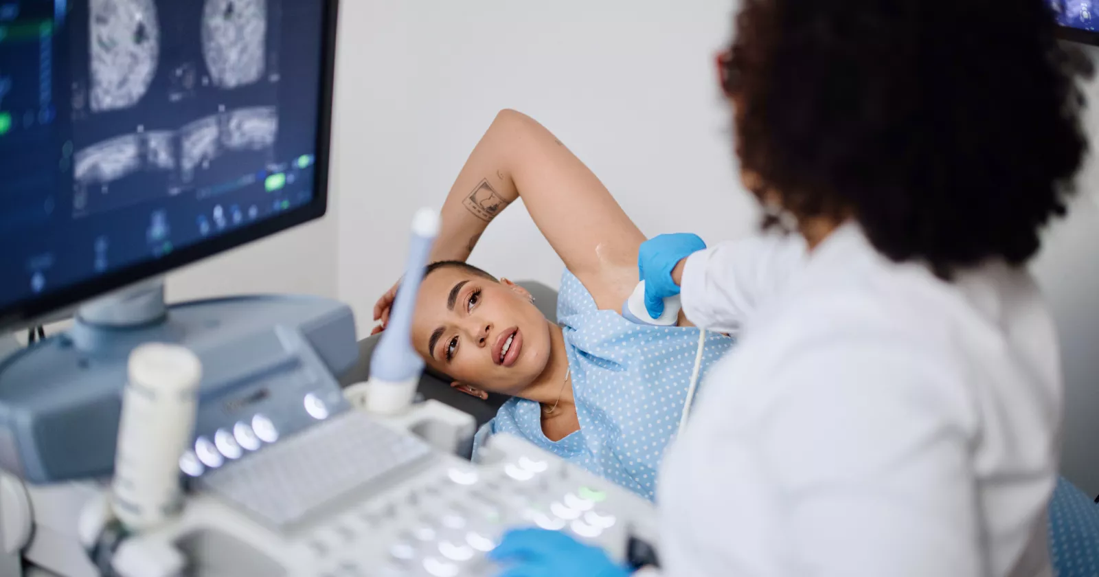 A young woman is doing a breast ultrasound for preventive breast cancer care