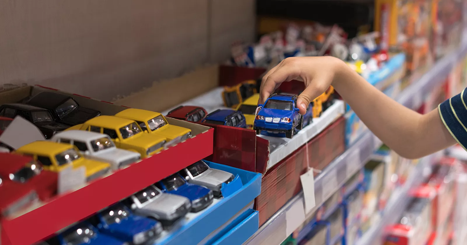 A young child plays with toy cars. Exponent Ph.D. scientists and engineers help manufacturers produce safer consumer products.