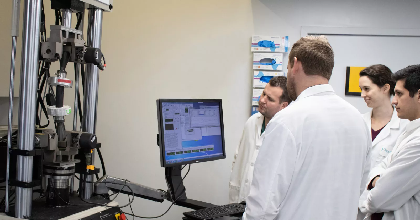 Young professionals observe data on a computer monitor.  Exponent is an exciting place to grow your technical consulting career. 