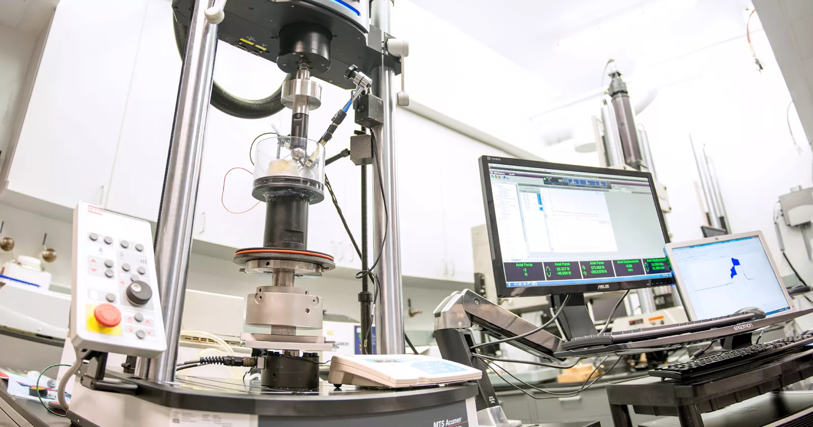 Scientific laboratory with testing machines and computers. Exponent's biomedical engineering laboratory.