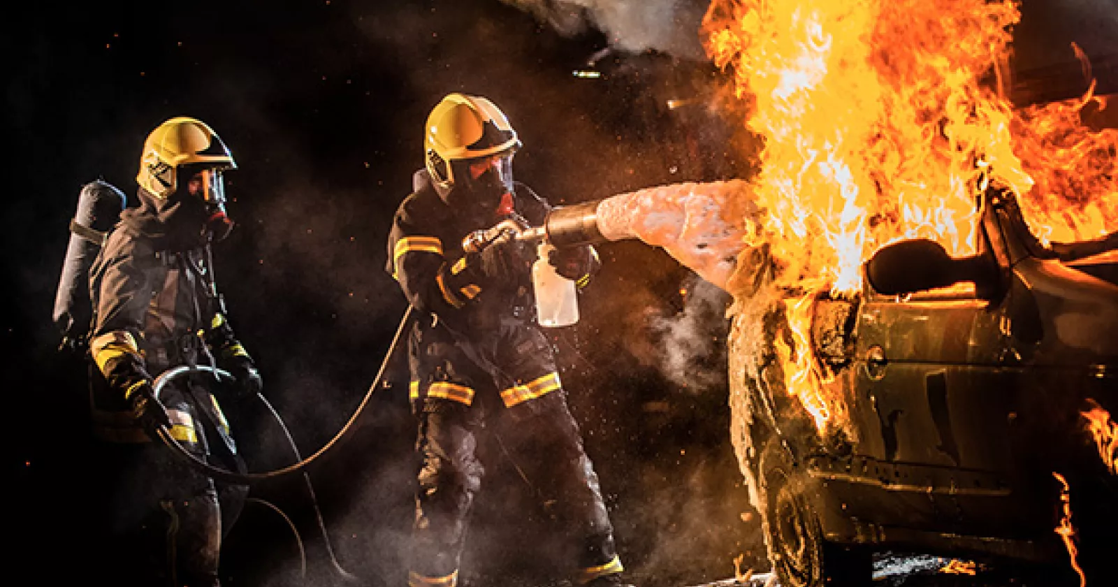 firefighters trying to put out car fire