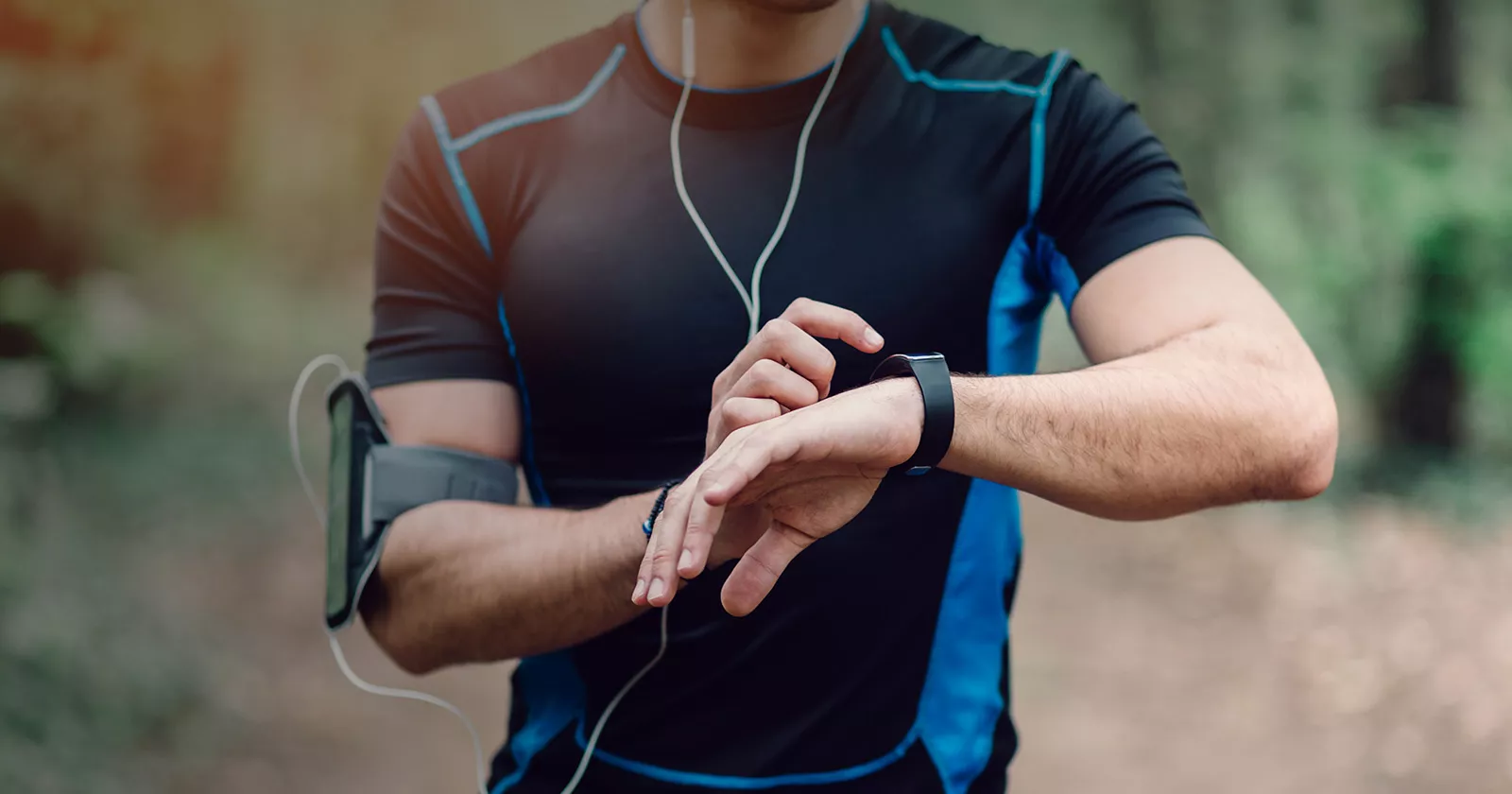 A runner stops to check their smartwatch. Exponent collects real-world evidence and expands data acquisition capabilities to improve healthcare. 