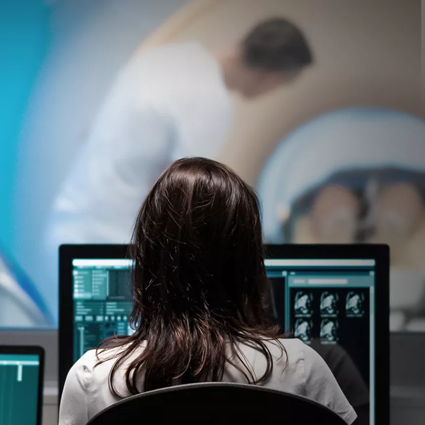 Medical researcher analyzes body scan images on computer screen. Exponent's consultants are leaders in health sciences innovations.