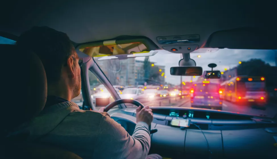 Driving a car in the city at night in traffic jams