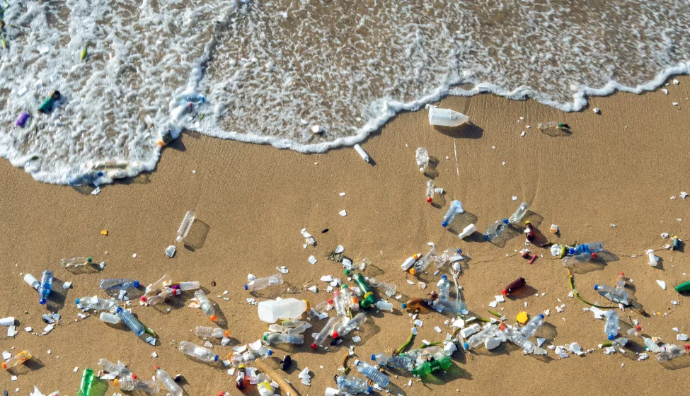 Waves pushing plastic waste to the beach